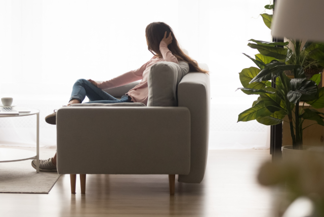 woman sitting on a sofa and looking into the distance