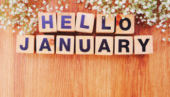 wooden blocks spelling out hello january, surrounded by baby's breath flowers