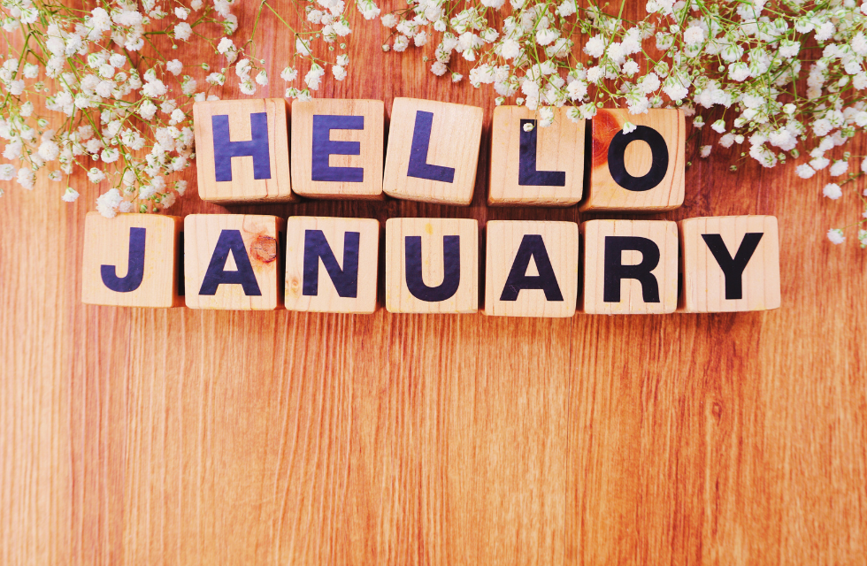 wooden blocks spelling out hello january, surrounded by baby's breath flowers